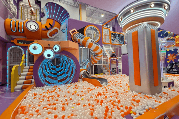 future world themed indoor playground with high-tech lighting designed for a modern family entertainment center.